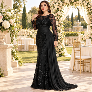 Side view of a plus size black sequin mermaid evening gown with sheer sleeves at an outdoor garden wedding