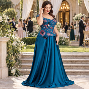Full-length front view of a teal blue formal gown featuring colorful floral embroidery and an elegant flowing skirt