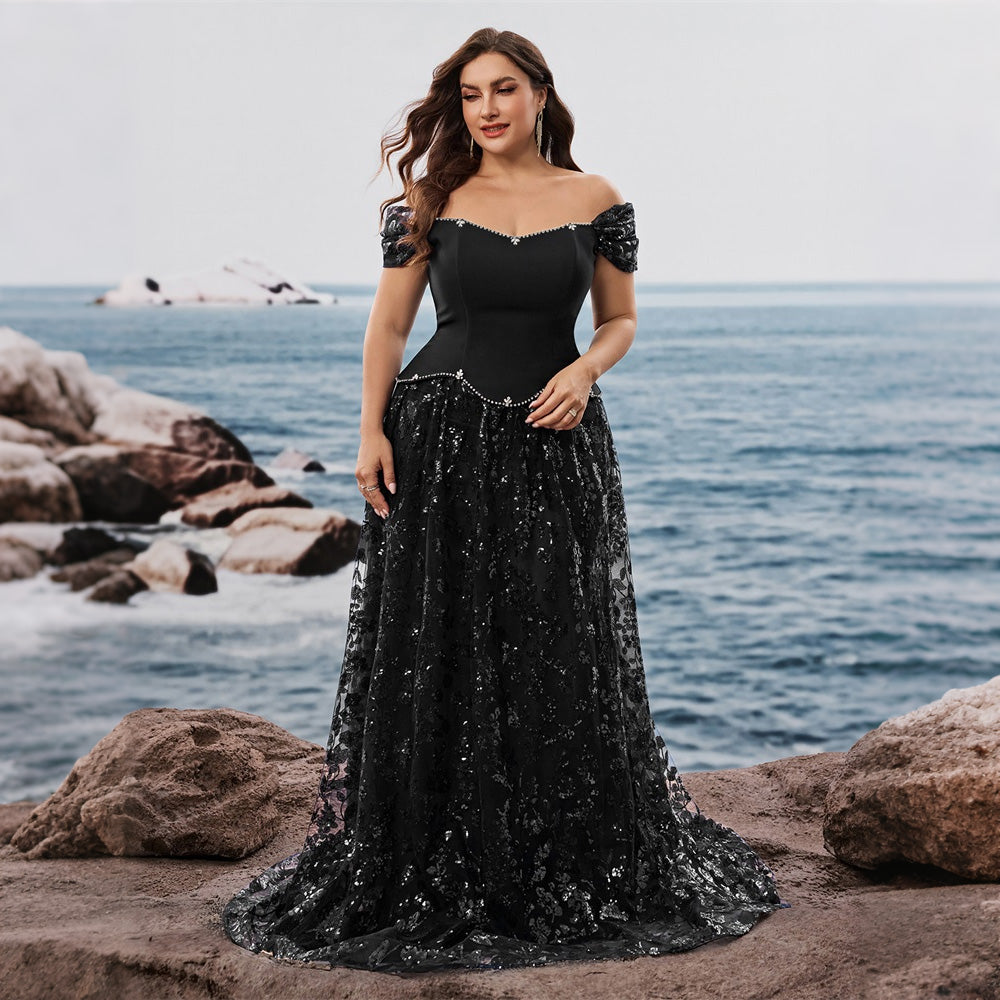 Side profile of a  model in a sweeping A-line gown by the ocean. Ideal semi formal evening wear for special occasions.